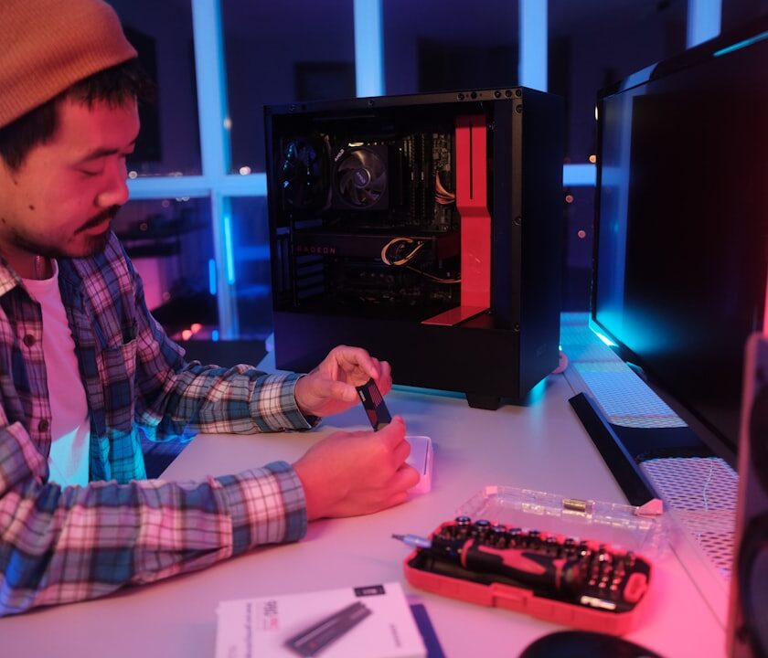 Computer Hardware Troubleshooting cover with a desktop tower, laptop, RAM stick, power cable, and screwdriver on a clean desk
